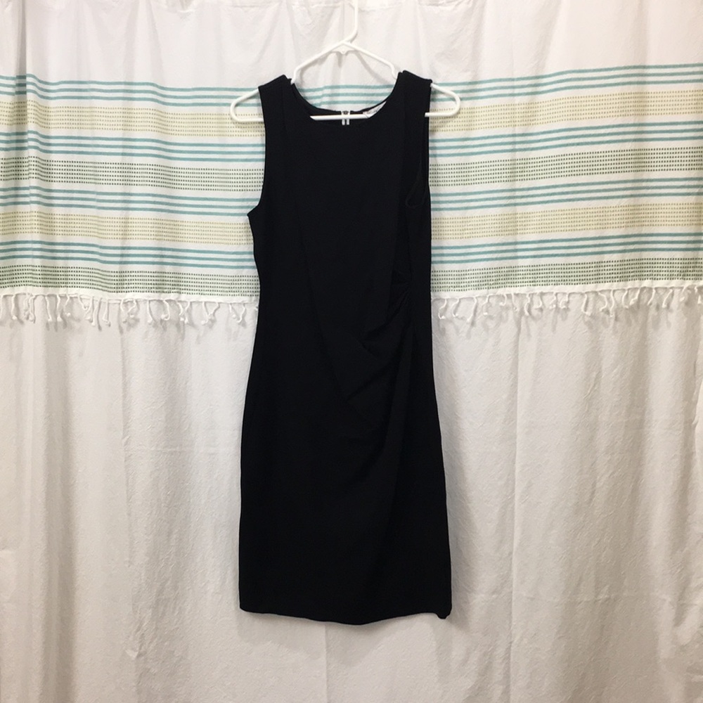 Black dress with white zipper down the back.